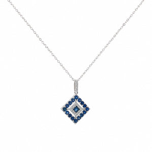 A delicate 14K white gold chain necklace featuring a geometric diamond-shaped pendant adorned with natural blue sapphires and sparkling white diamonds, displayed on a clean white studio background.