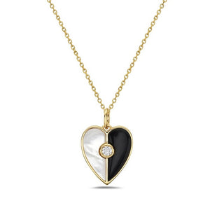 Heart-shaped pendant with gold frame, black and white center, and diamond on a white background