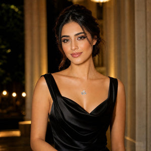 Woman wearing a black dress with a necklace in an elegant setting