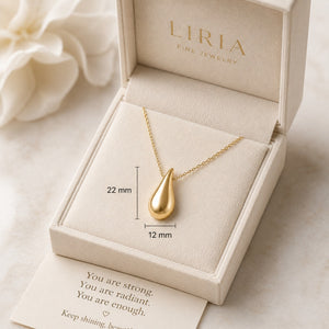Gold teardrop necklace in a LIRIA jewelry box with a message card.