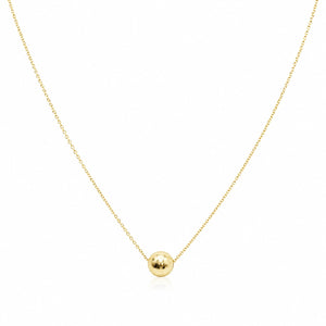 Gold necklace with a small round pendant on a white background