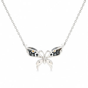 Butterfly-shaped silver pendant on a chain against a white background