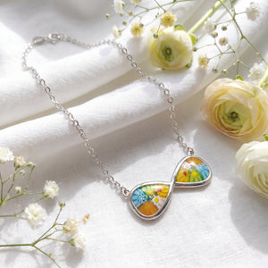 Necklace with floral pendant on a white fabric background