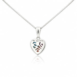 Silver heart-shaped pendant with engraved design on a white background