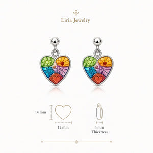 Heart-shaped earrings with colorful floral design by Liria Jewelry on a white background.