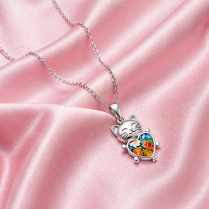 Cat-shaped pendant with colorful design on a pink satin background
