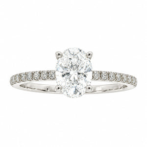 An oval diamond engagement ring with a brilliant-cut center stone in a four-prong setting, featuring a pavé band set with small round diamonds in a silver-colored metal, shown on a plain white background.