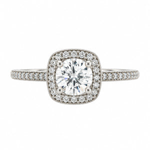 A square halo engagement ring featuring a round brilliant-cut center diamond surrounded by a double halo of smaller diamonds, set on a silver-colored band with pavé diamonds, shown against a plain white background.