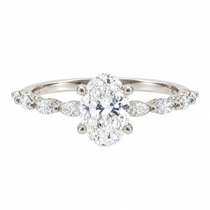 An oval diamond engagement ring with a brilliant center stone and marquise-cut side stones on a polished silver-colored band, set against a plain white background.