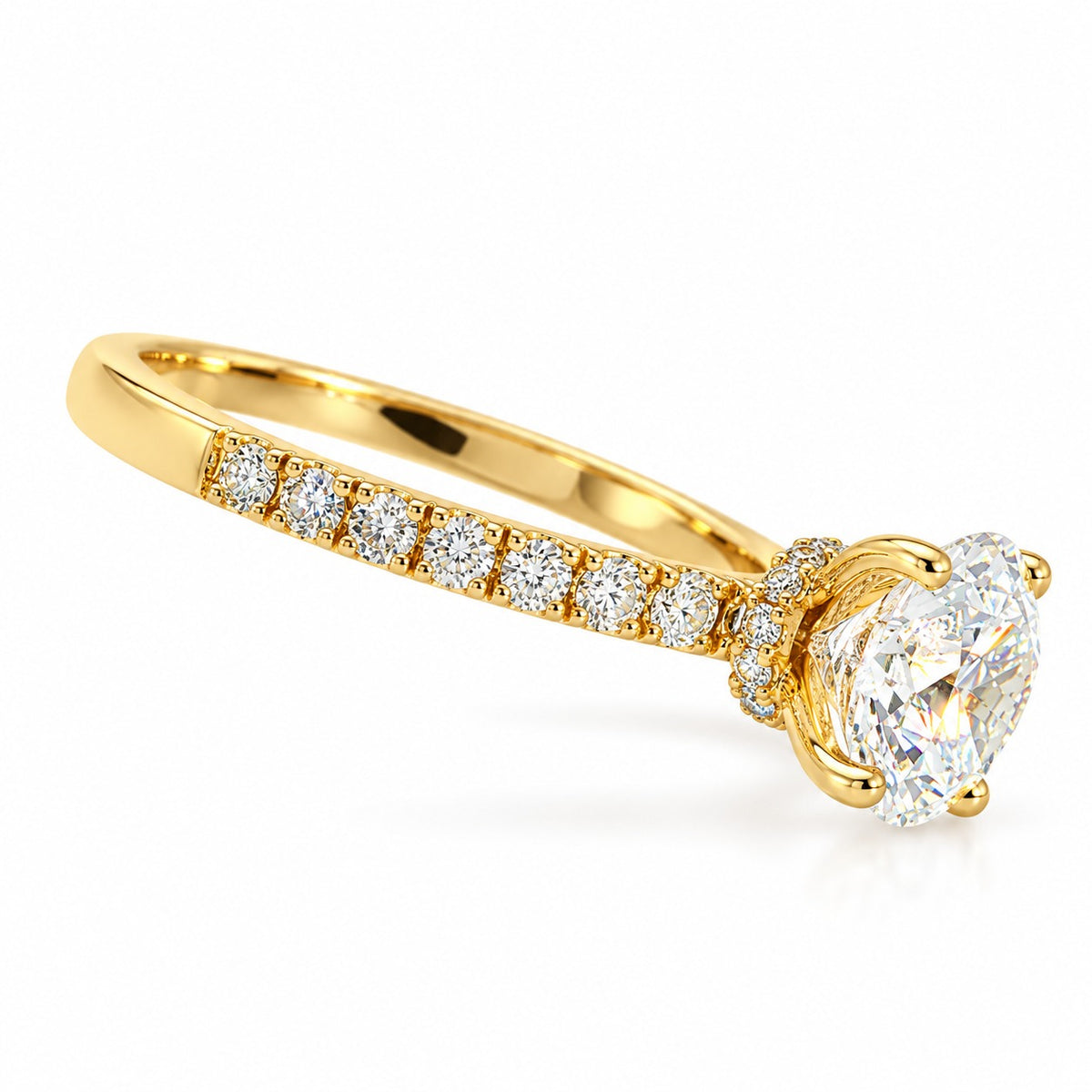 A yellow gold solitaire engagement ring featuring a large oval-cut diamond center stone and a row of smaller round diamonds along the band, set against a clean white background.