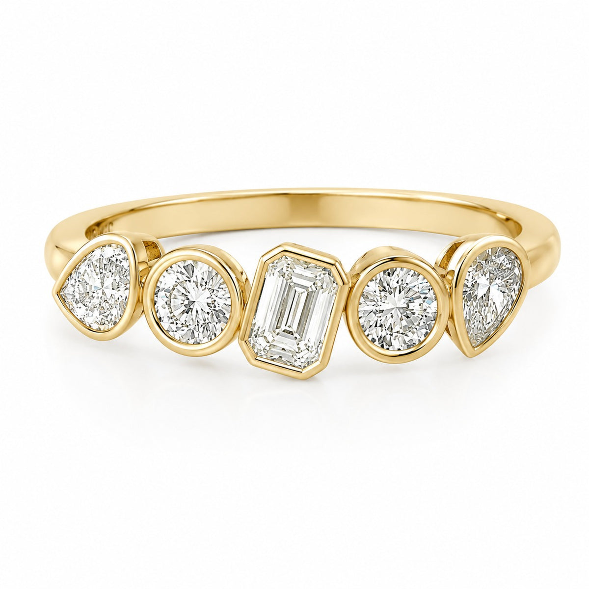 Yellow gold diamond ring featuring an emerald-cut center diamond accented by round and pear-shaped bezel-set diamonds on a polished band, displayed on a light gray background.