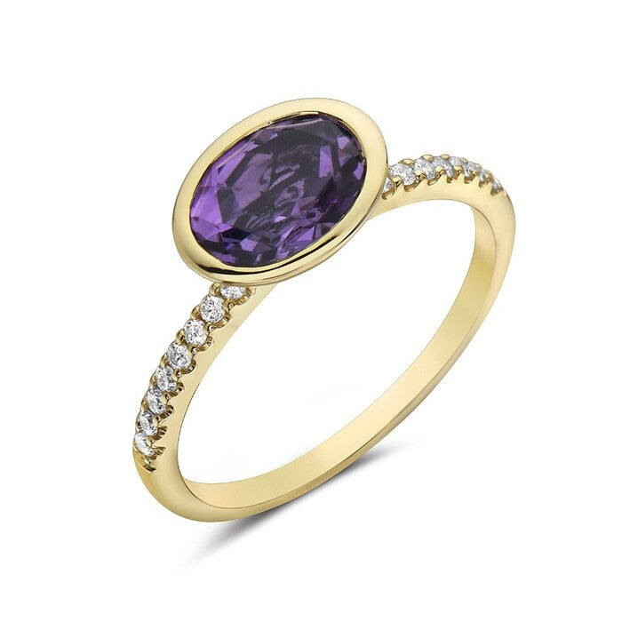 Gold ring with a purple gemstone and diamond accents on a white background