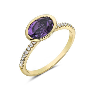 Gold ring with a purple gemstone and diamond accents on a white background