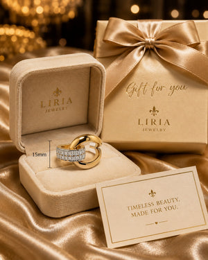 Liria Jewelry ring in an open box with a matching gift box and card on a satin surface.