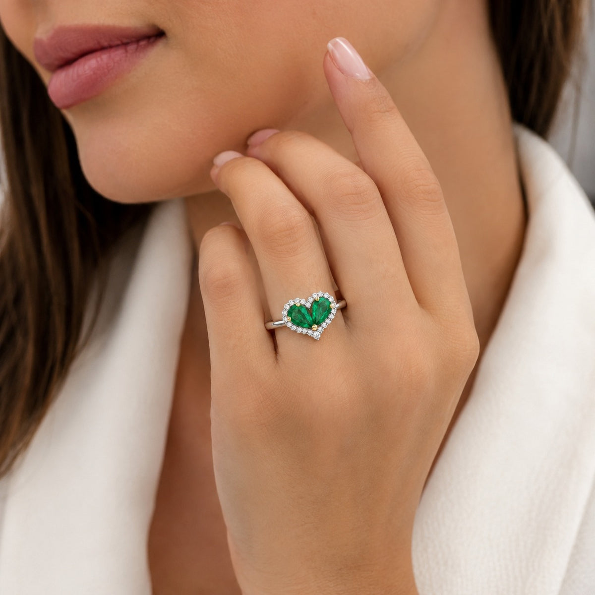 Heart-shaped green gemstone ring on a model