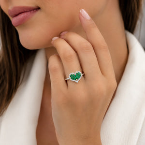 Heart-shaped green gemstone ring on a model