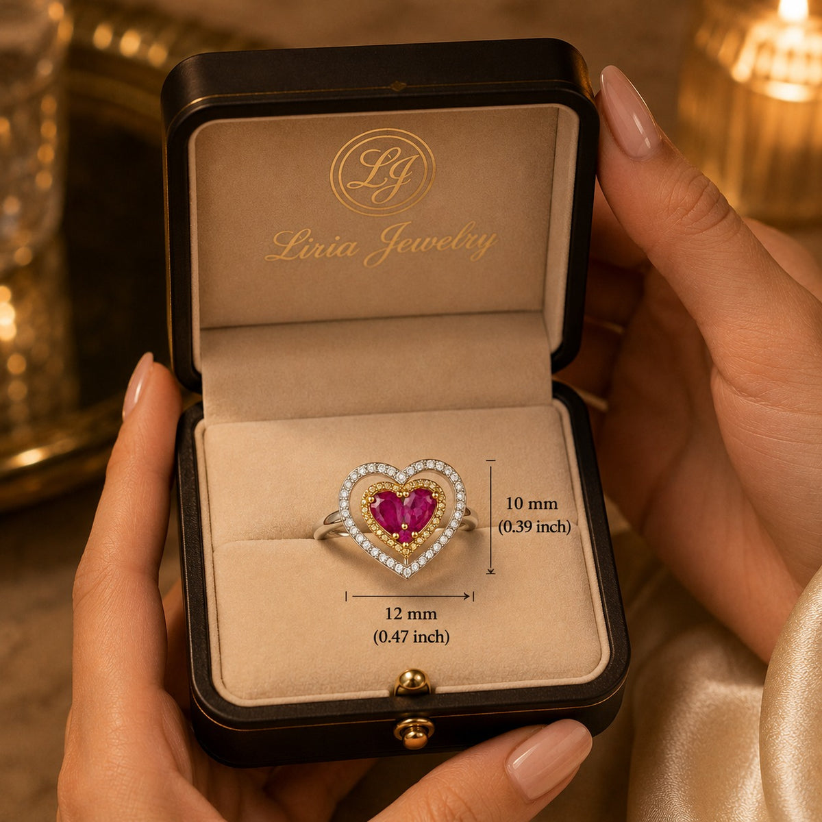 18K two-tone gold heart ring featuring two heart-shaped rubies surrounded by a yellow gold halo and an open white gold heart accented with sparkling diamonds.