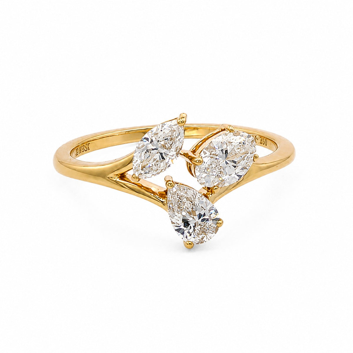 A yellow gold ring featuring three marquise-cut diamonds on a split shank, photographed on a clean white background.