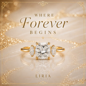 A gold solitaire-style ring with a large square clear center stone and two smaller marquise-cut side stones, displayed on a soft champagne background with decorative text reading 'WHERE Forever BEGINS' and 'LIRIA JEWELRY'.