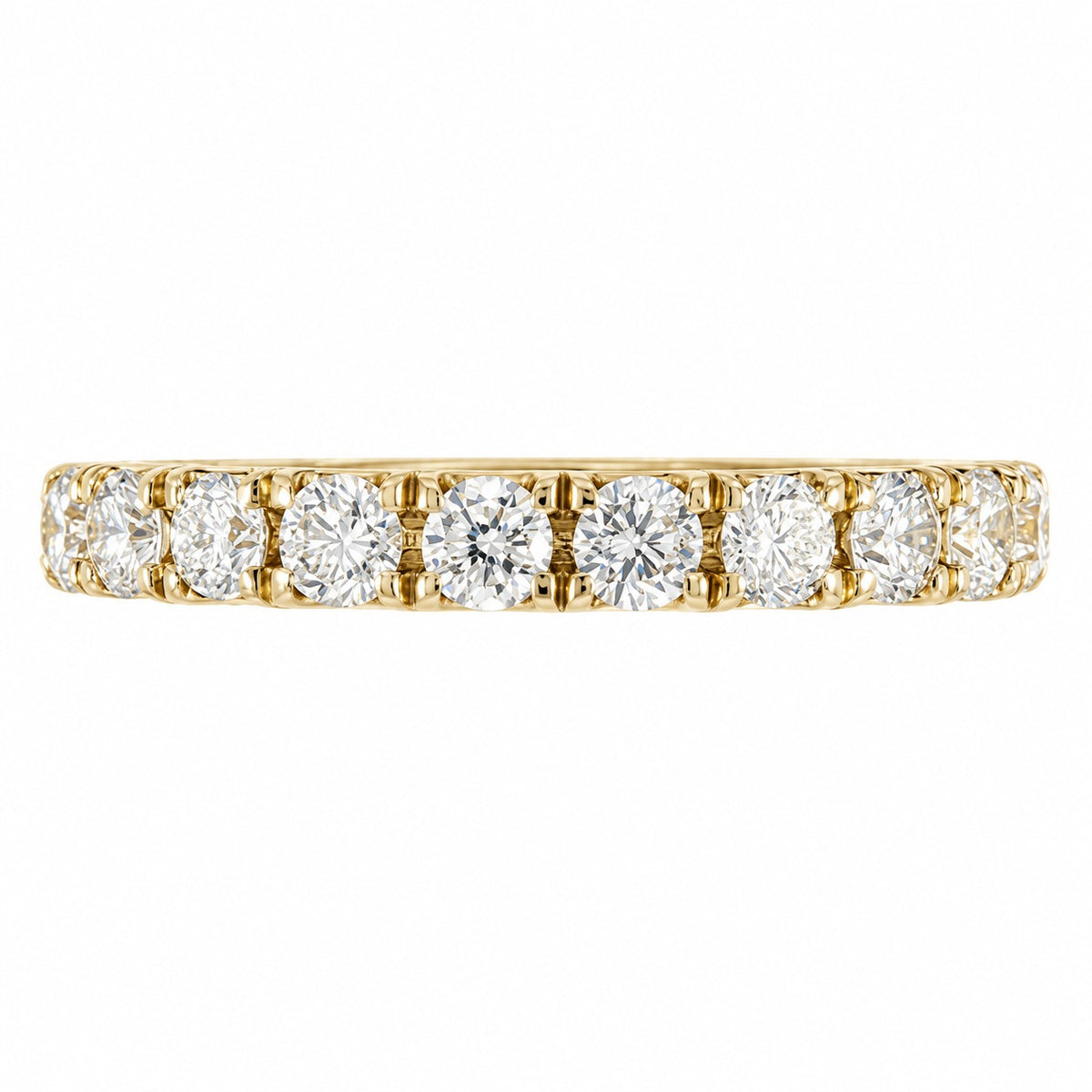 A yellow gold eternity ring featuring a row of round brilliant-cut diamonds set in a prong style, shown against a plain white background.