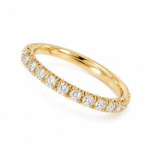 A yellow gold eternity ring featuring a continuous row of round-cut clear gemstones on a white background.
