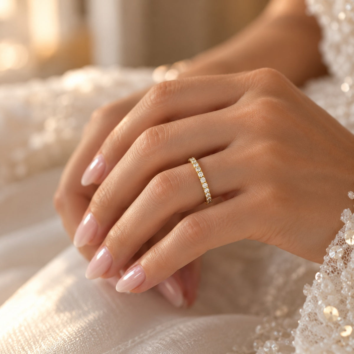 Bride wearing a slim 14K yellow gold wedding band with 17 round lab-grown diamonds totaling 0.23 CT, showcasing its delicate sparkle.