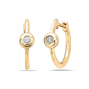 Gold hoop earrings with embedded diamonds on a white background