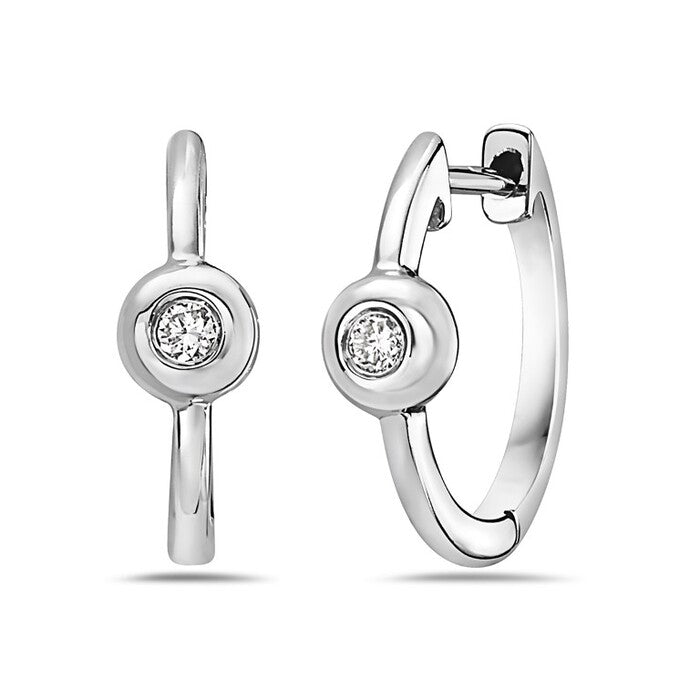 Pair of silver hoop earrings with clear gemstones on a white background