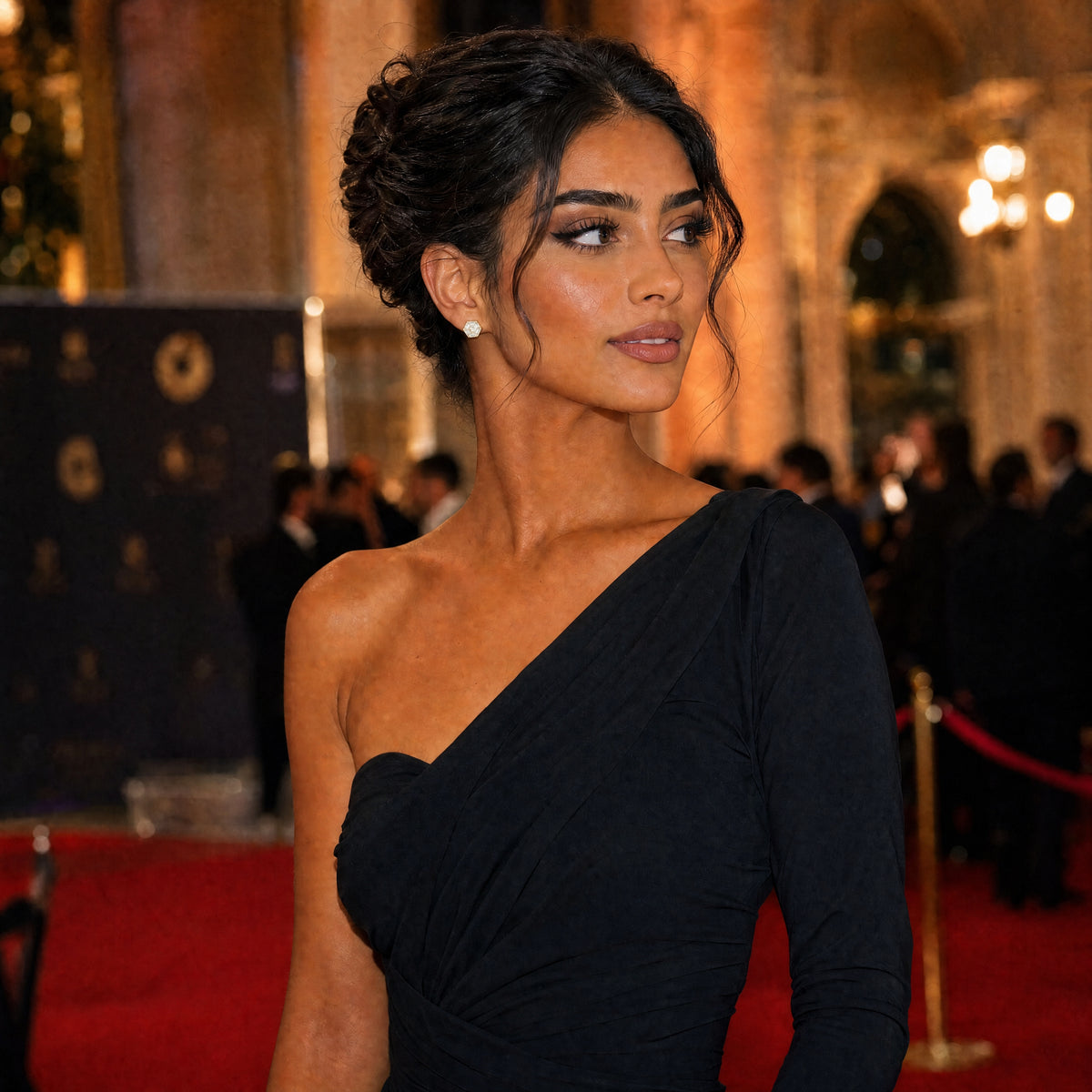 Woman in a black dress on a red carpet with a blurred background