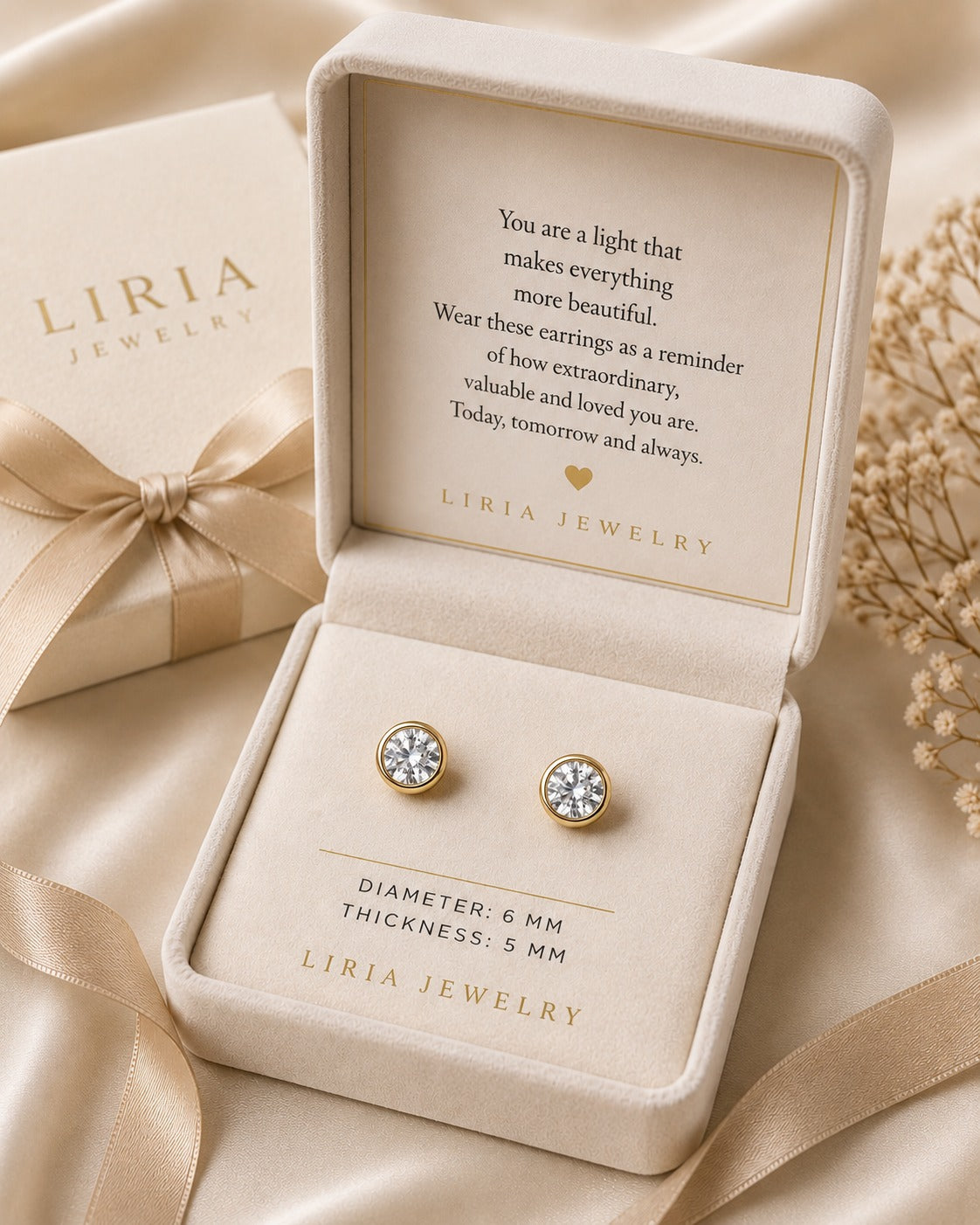 LIRIA Jewelry earrings in a box with a sentimental message on a beige background