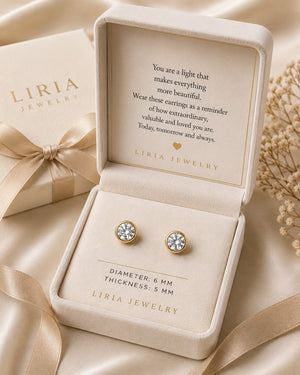 LIRIA Jewelry earrings in a box with a sentimental message on a beige background