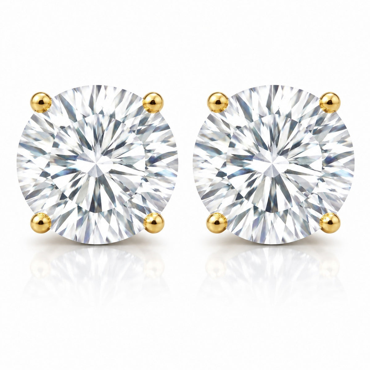 Pair of diamond stud earrings with gold prongs on a white background