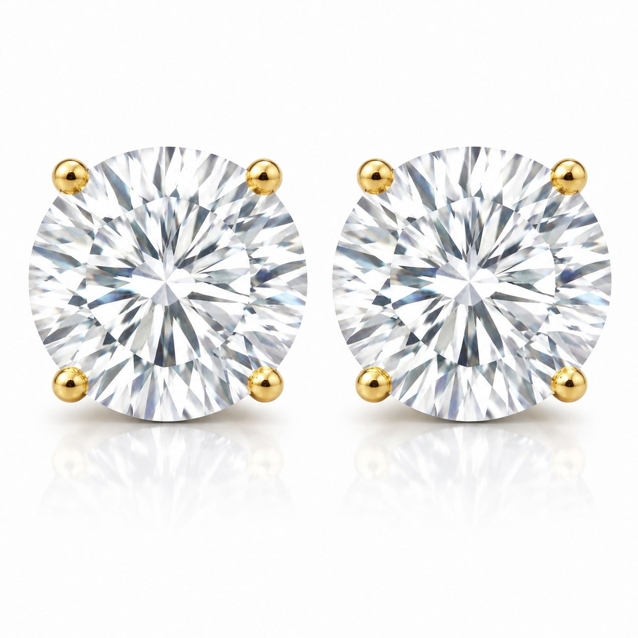 Pair of diamond stud earrings with gold prongs on a white background