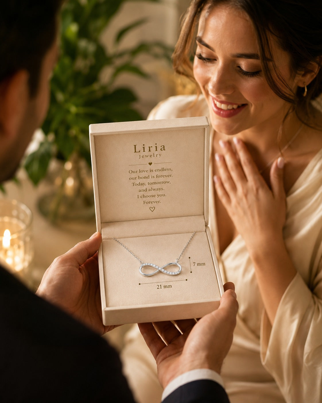 Person holding an open jewelry box with an infinity necklace, smiling at a woman.