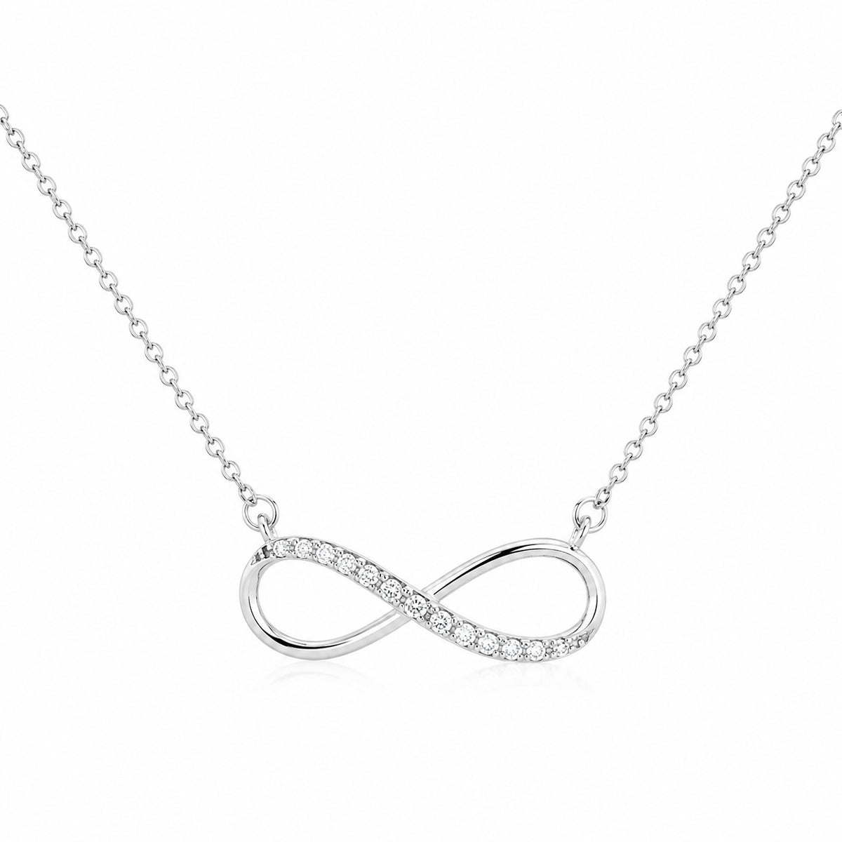 Silver infinity necklace with small diamonds on a white background