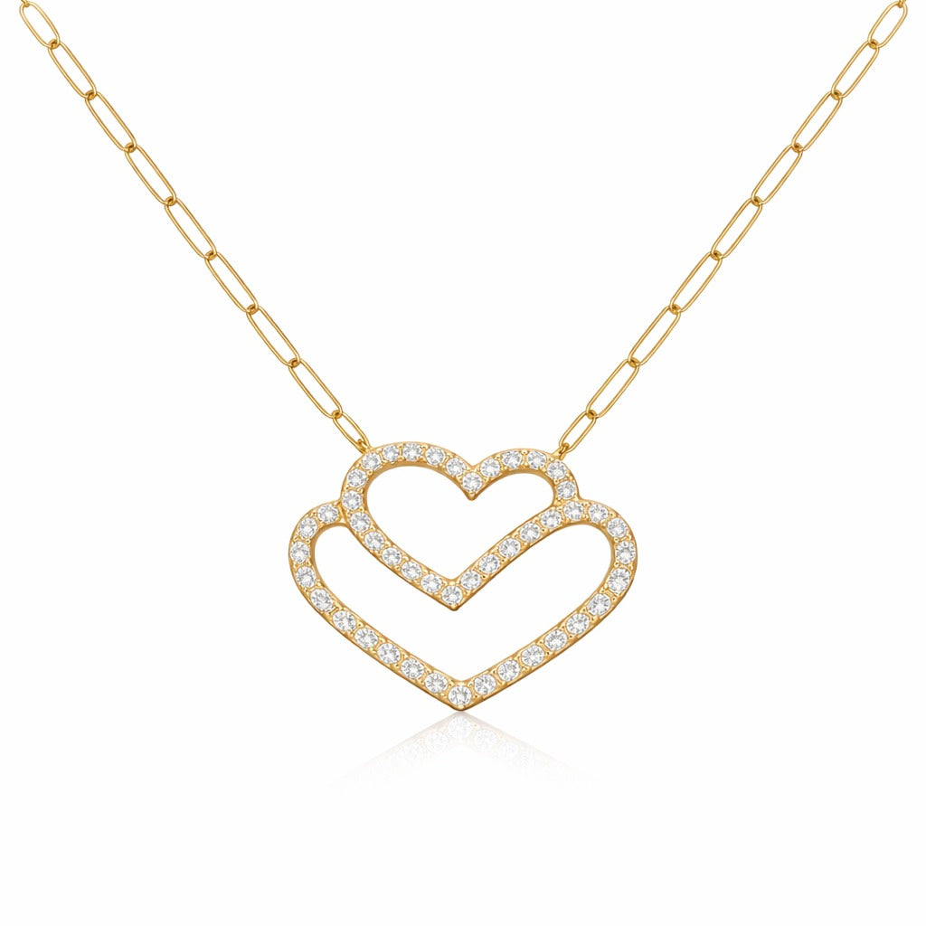 Gold necklace with a heart-shaped pendant on a white background
