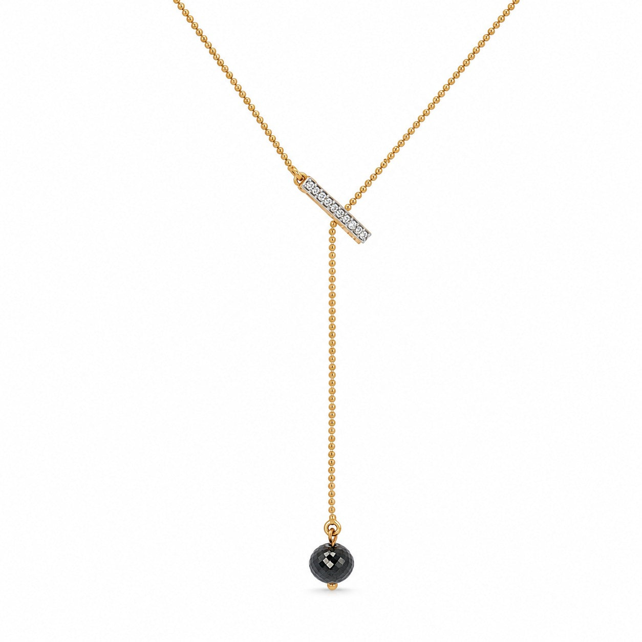 A gold Y-necklace featuring a horizontal bar pavé-set with clear stones and a dangling beaded chain ending in a round black gemstone pendant, shown on a plain white background.