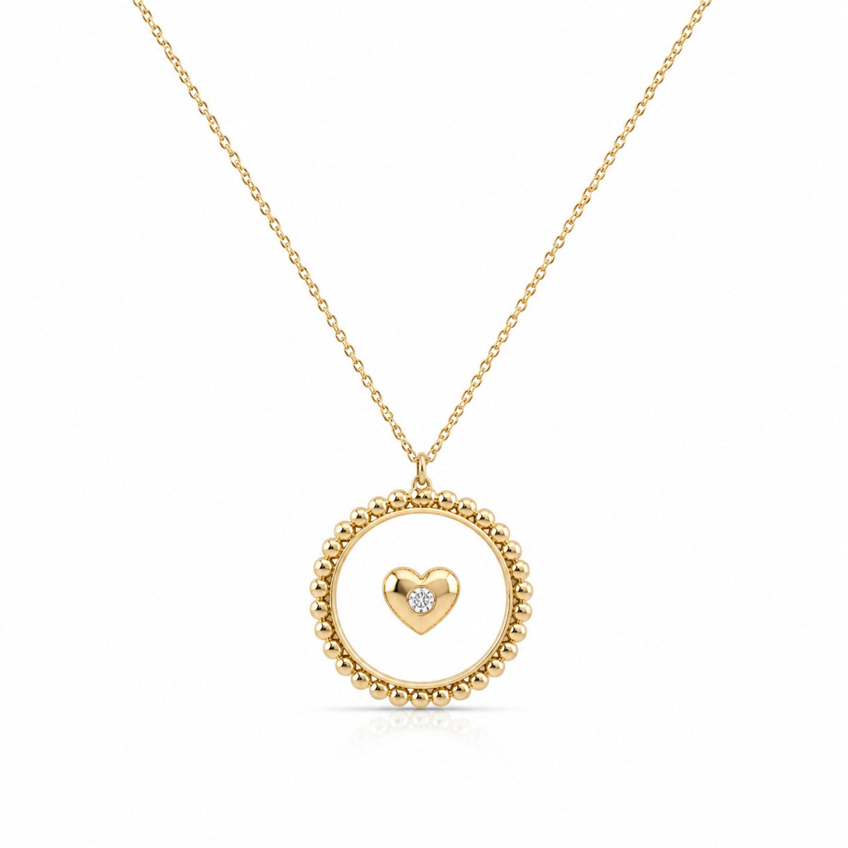 Gold necklace with a heart-shaped pendant on a white background