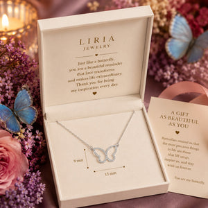 Butterfly necklace in LIRIA Jewelry box with flowers and butterfly decorations.