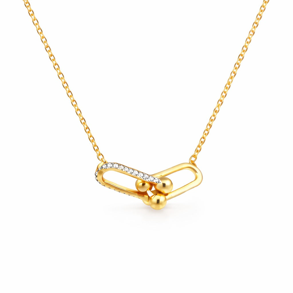 Gold necklace with a unique pendant on a white background