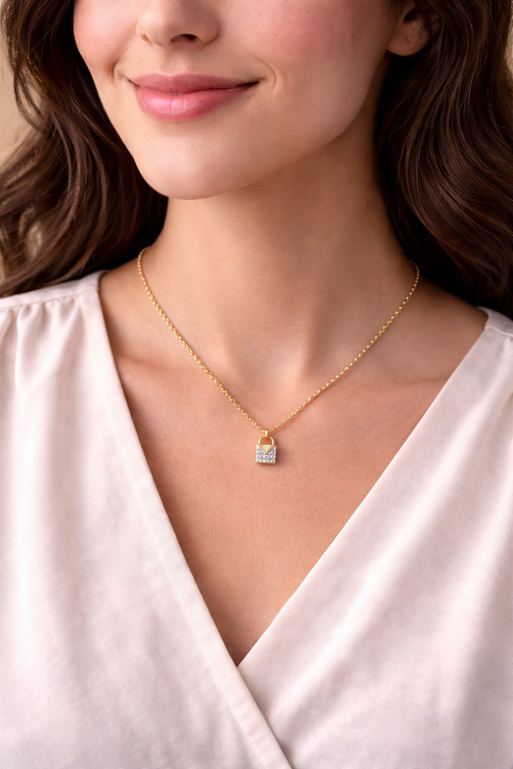 Close-up of a woman wearing a gold necklace with a small pendant.