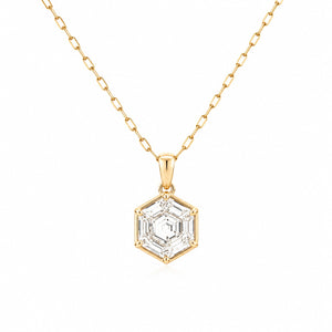 Gold necklace with a hexagonal diamond pendant on a white background
