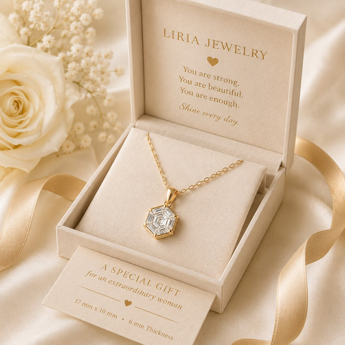 Gold necklace in Liria Jewelry box with decorative flowers and ribbon