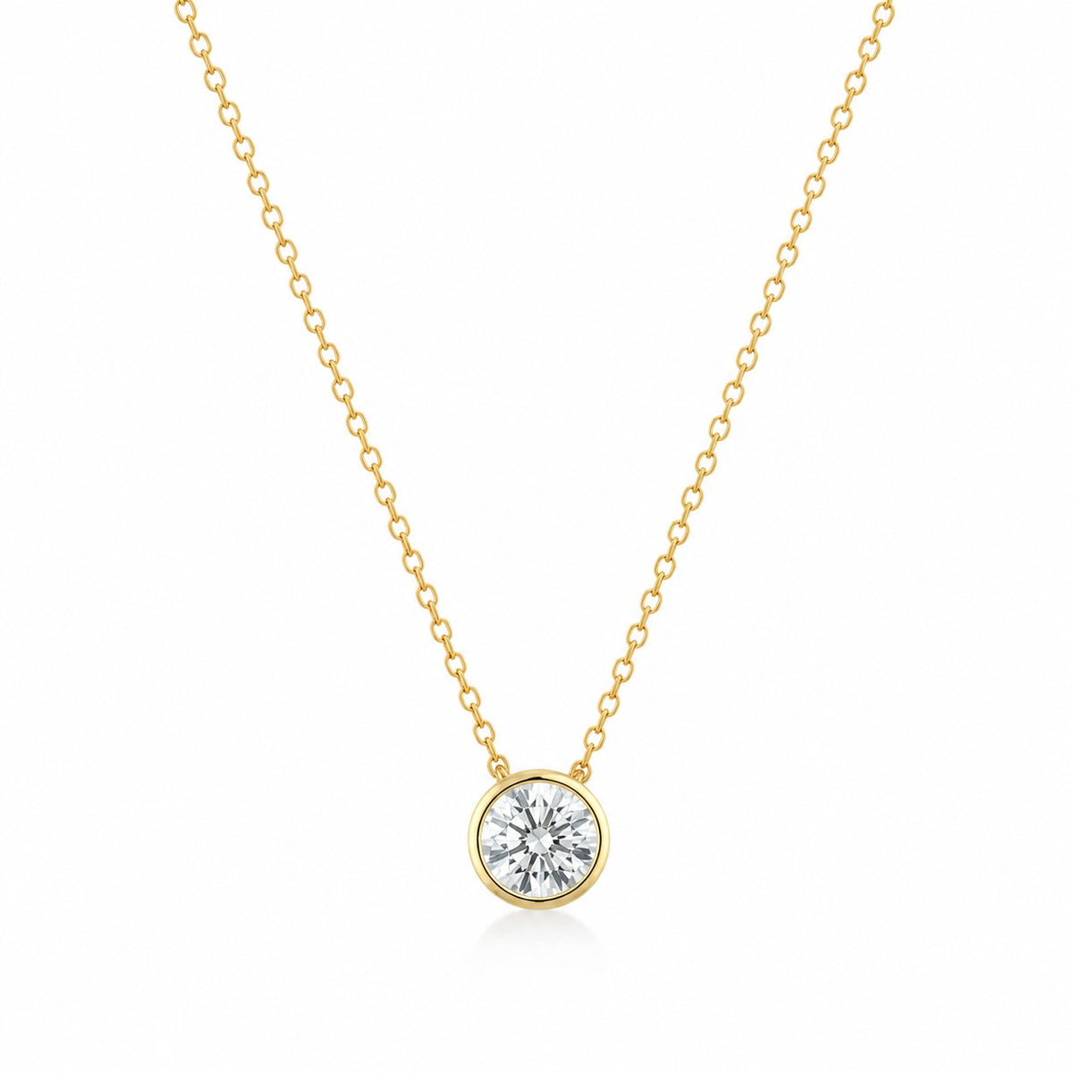 Gold necklace with a round diamond pendant on a white background