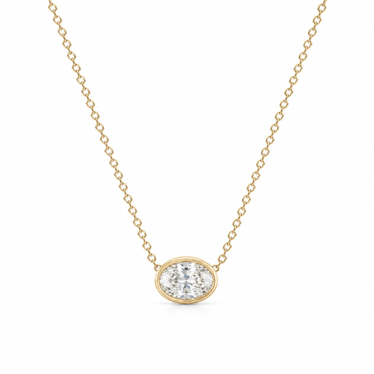 Gold necklace with a diamond pendant on a white background