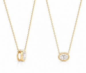 Two gold necklaces with diamond pendants on a white background
