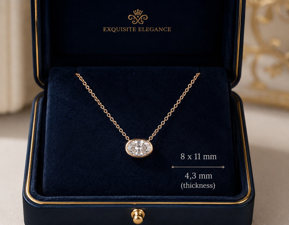 Gold necklace with a diamond pendant in an 'Exquisite Elegance' box.