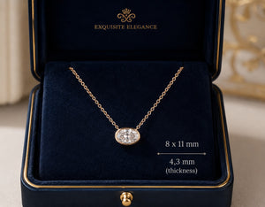 Gold necklace with a diamond pendant in an 'Exquisite Elegance' box.