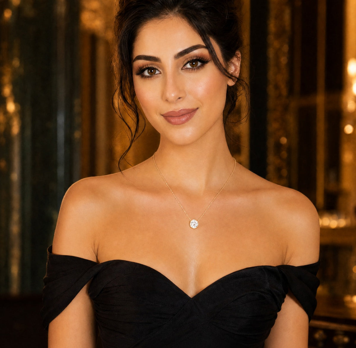 Woman wearing a black off-shoulder dress with a diamond necklace against a blurred background