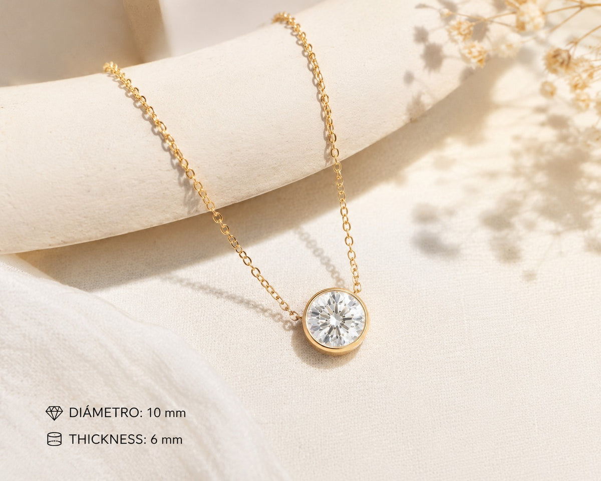 Gold necklace with a diamond pendant on a soft beige background